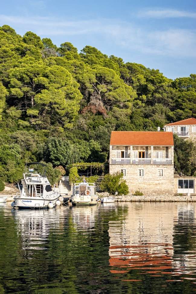 House and boat by the water