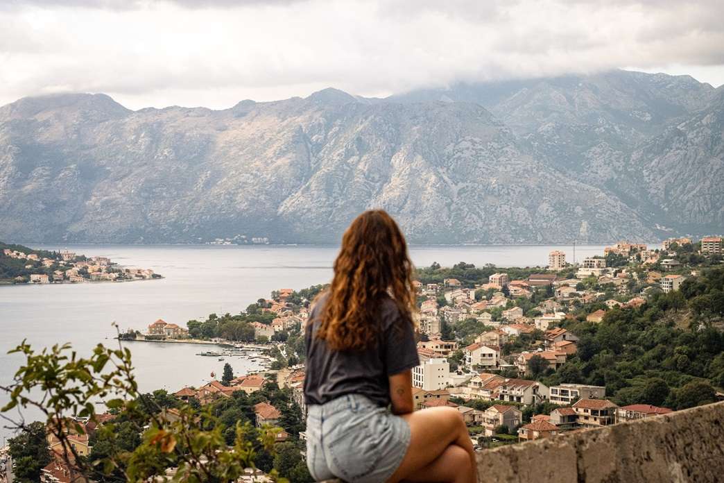 Person looking out on a city and bay