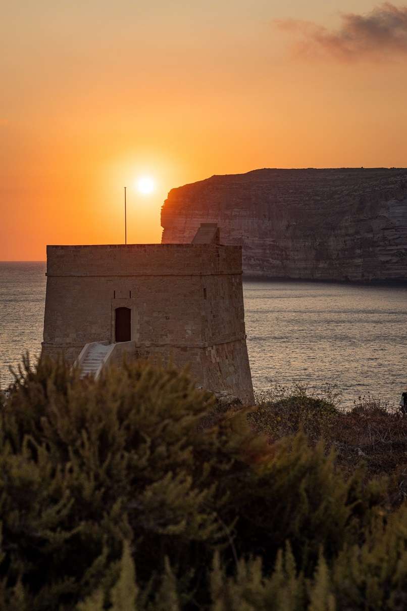 Watching the sunset from Xlendi in Gozo, Malta.