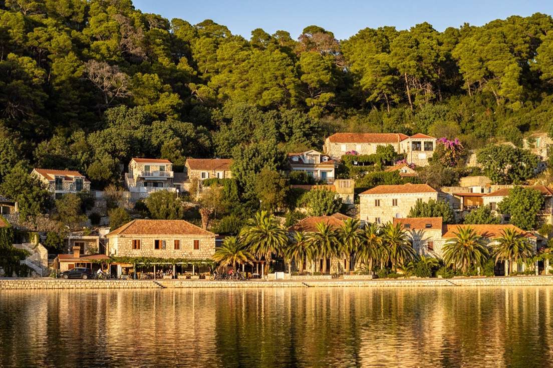 Houses and forest reflecting in the water